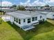 Inviting home with a screened-in porch and well-kept lawn, ideal for comfortable living and outdoor enjoyment at 425 Pirates Pt, North Port, FL 34287