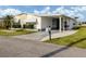 Quaint single-story home with a convenient carport and well-maintained front lawn at 425 Pirates Pt, North Port, FL 34287