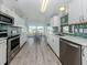 Updated kitchen with stainless steel appliances and green tile backsplash, with pond view at 425 Pirates Pt, North Port, FL 34287