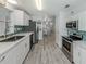 Modern kitchen with stainless steel appliances and an open concept to the living and dining areas at 425 Pirates Pt, North Port, FL 34287