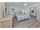 Relaxing main bedroom with coastal decor, light grey floors and ensuite bathroom at 425 Pirates Pt, North Port, FL 34287