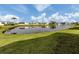 Scenic view of the community pond surrounded by lush greenery and various residences at 425 Pirates Pt, North Port, FL 34287