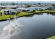 Scenic pond view with a fountain, complemented by lush greenery, perfect for a peaceful retreat at 425 Pirates Pt, North Port, FL 34287