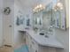 Bright bathroom with a large vanity mirror, clean lines, and fresh decor at 443 Landsedge Dr, North Port, FL 34287