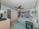 Cozy bedroom with light blue walls, carpet, a ceiling fan, and convenient closet storage at 443 Landsedge Dr, North Port, FL 34287