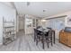 Cozy dining area featuring modern light fixtures, wood table, and stylish decor at 443 Landsedge Dr, North Port, FL 34287