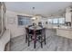 Charming dining area connected to the kitchen with new flooring and a modern pendant light at 443 Landsedge Dr, North Port, FL 34287