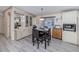 A sunlit dining area featuring hardwood floors, contemporary furnishings, and built-in cabinets at 443 Landsedge Dr, North Port, FL 34287