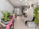 Enclosed Florida room with white tiled floor, multiple ceiling fans, and plenty of space for relaxing at 443 Landsedge Dr, North Port, FL 34287