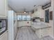 Bright kitchen with crisp white cabinets, granite countertops, and modern appliances at 443 Landsedge Dr, North Port, FL 34287