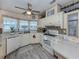 Well-lit kitchen with new flooring, white cabinets, and a stylish backsplash at 443 Landsedge Dr, North Port, FL 34287