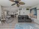 An open-concept living space with hardwood floors, a ceiling fan, and seamlessly connected to the dining area at 443 Landsedge Dr, North Port, FL 34287