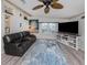 An inviting living area with comfortable seating, beach themed accents, and hardwood flooring at 443 Landsedge Dr, North Port, FL 34287