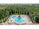 Stunning community pool and hot tub area surrounded by tropical landscaping at 4641 Gaeta Dr, Venice, FL 34293