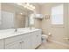 Bright bathroom featuring a double sink vanity, tiled shower, and plenty of natural light at 4641 Gaeta Dr, Venice, FL 34293