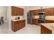 Spacious kitchen featuring dark wood cabinetry, stainless steel appliances, and ample counter space, perfect for cooking and dining at 4641 Gaeta Dr, Venice, FL 34293