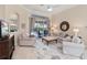 Cozy living room featuring neutral decor, access to the outdoor area, and comfortable seating, creating a relaxing atmosphere at 4641 Gaeta Dr, Venice, FL 34293