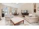 Open-concept living space with comfortable seating, tiled floors, and a dining area, perfect for entertaining and daily living at 4641 Gaeta Dr, Venice, FL 34293