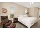 Comfortable primary bedroom featuring neutral walls, plush carpet, and an inviting leather chair at 4641 Gaeta Dr, Venice, FL 34293