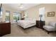 Bright primary bedroom with access to the lanai, neutral carpet, and comfortable furnishings at 4641 Gaeta Dr, Venice, FL 34293