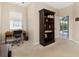 Office space with large bookshelf and a view of the pool and screened in porch at 4641 Gaeta Dr, Venice, FL 34293