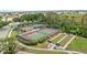 Beautiful aerial view of tennis and bocce ball courts surrounded by lush greenery at 4641 Gaeta Dr, Venice, FL 34293