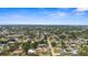 Expansive aerial view of a residential neighborhood with lush greenery and clear blue skies at 511 Porpoise Rd, Venice, FL 34293