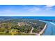 Expansive aerial view of the community with lush greenery, ocean access, a river and a serene waterway at 511 Porpoise Rd, Venice, FL 34293
