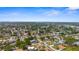 Aerial view of a residential area with lush greenery, sidewalks, and a variety of single-Gathering homes at 511 Porpoise Rd, Venice, FL 34293
