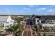Aerial view of a charming business district with brick paved street, lush trees, and shops at 511 Porpoise Rd, Venice, FL 34293