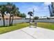 Spacious backyard with a patio area, surrounded by a privacy fence and palm trees at 511 Porpoise Rd, Venice, FL 34293