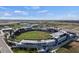 Aerial view of a modern baseball stadium with lush green field, surrounded by buildings and parking at 511 Porpoise Rd, Venice, FL 34293