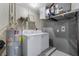 Functional basement area housing the laundry equipment and water heater at 511 Porpoise Rd, Venice, FL 34293