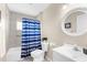 Bathroom with a shower and tub combination, a white vanity, and decorative mirror at 511 Porpoise Rd, Venice, FL 34293