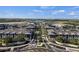 Aerial view of a new modern community, showcasing residential buildings, streets, and landscaping at 511 Porpoise Rd, Venice, FL 34293