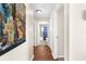 Hallway showcases hardwood floors with views of an updated bathroom at 511 Porpoise Rd, Venice, FL 34293