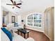 Bright living room featuring a ceiling fan, a large window, and comfortable seating arrangement at 511 Porpoise Rd, Venice, FL 34293