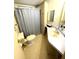 Functional bathroom featuring a toilet, vanity with sink, and shower with a patterned curtain at 537 Amberjack Dr, North Port, FL 34287