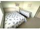 Comfortable bedroom with two twin beds, light green walls, and neutral carpeting at 537 Amberjack Dr, North Port, FL 34287