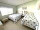 Cozy bedroom featuring twin beds with matching seashell-themed bedding, ideal for guests or children at 537 Amberjack Dr, North Port, FL 34287