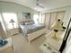 Inviting bedroom featuring a large bed, ceiling fan, soft lighting, and an ensuite bath for added convenience at 537 Amberjack Dr, North Port, FL 34287