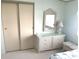 Bedroom storage with a woven dresser, mirror, and closet at 537 Amberjack Dr, North Port, FL 34287