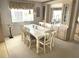 Dining area with a large table, neutral color palette, and coordinated decor at 537 Amberjack Dr, North Port, FL 34287
