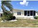 Inviting single-story home with screened front porch, manicured lawn and attractive landscaping at 537 Amberjack Dr, North Port, FL 34287