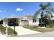 Inviting home with a car port, palm tree, manicured lawn, and a front-facing mailbox at 537 Amberjack Dr, North Port, FL 34287