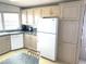 Traditional kitchen features ample cabinetry, appliances, and a dining area with natural light from a window at 537 Amberjack Dr, North Port, FL 34287