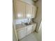 Kitchenette includes upper and lower cabinets with neutral countertops and decorative accents at 537 Amberjack Dr, North Port, FL 34287