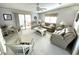 Bright living room with neutral tones, comfortable seating, and sliding glass doors at 537 Amberjack Dr, North Port, FL 34287