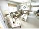 Inviting living room with soft lighting, plush furniture, and a view into dining area at 537 Amberjack Dr, North Port, FL 34287