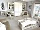 Bright living room with comfortable seating, built-in shelving, and floral decor at 537 Amberjack Dr, North Port, FL 34287